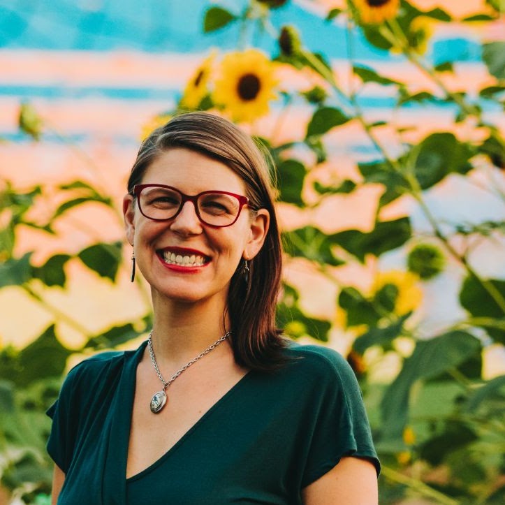 Rev. Celeste Kennel-Shank, pastor of Moveable Feast, standing among sunflowers