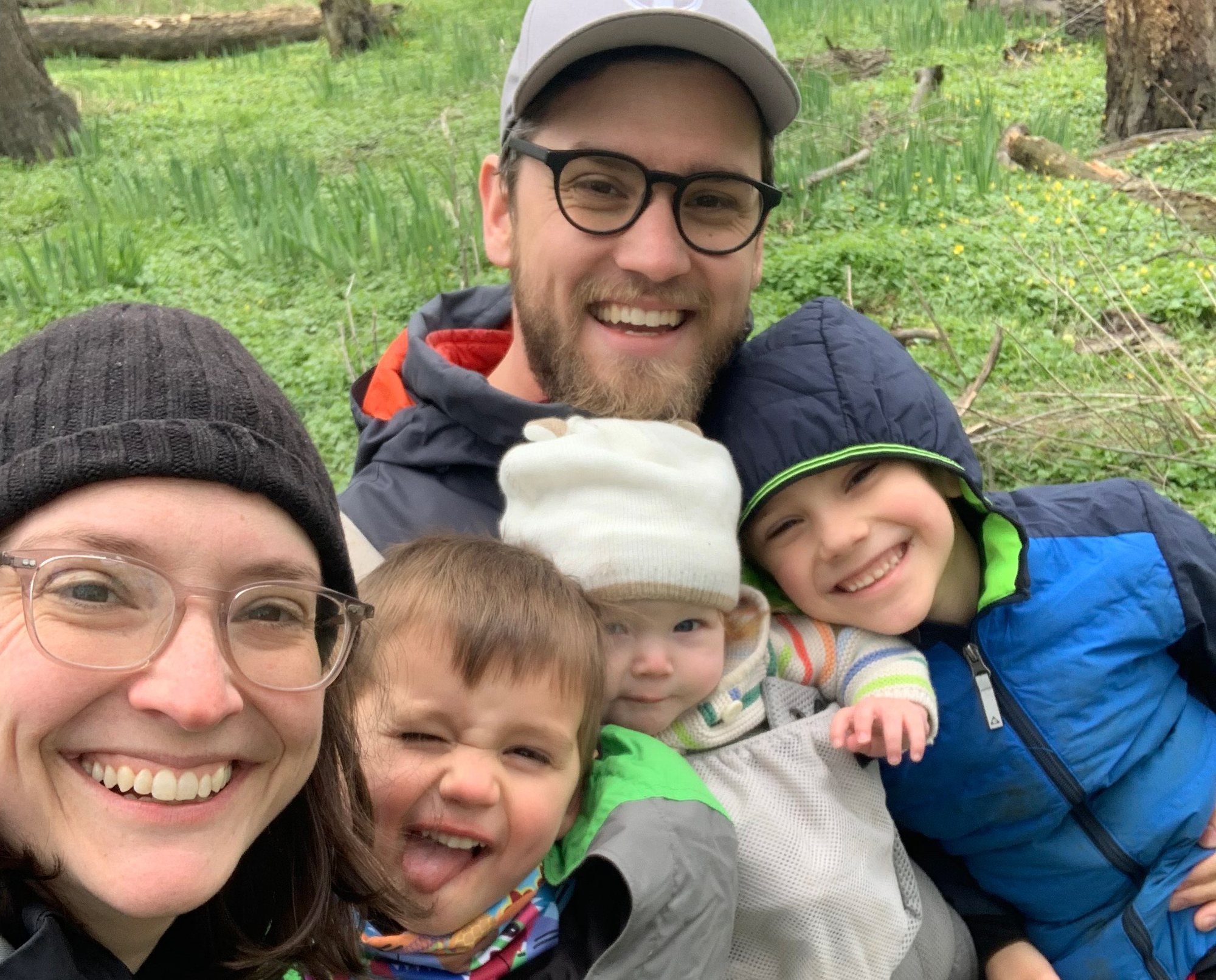 Liann and her family smiling together outdoors